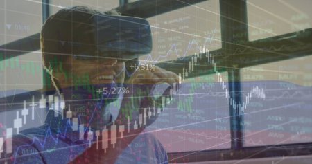 Image of data processing over caucasian man using vr headset. Global business and digital interface concept digitally generated image.