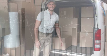 Photo for Rear view of a Caucasian deliveryman loading packages in the back of a delivery van. He then pauses and smiles at the camera. Digital image of graphs and statistics are running in the foreground - Royalty Free Image