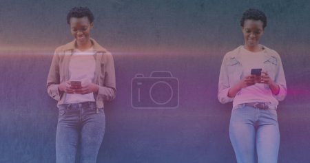 Image of smiling african american women using smartphones. national siblings day and celebration concept digitally generated image.