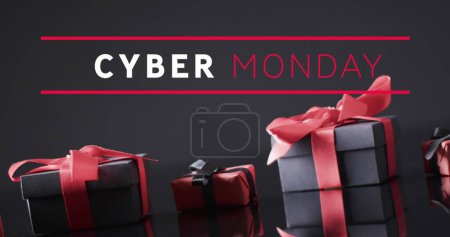 Image of cyber monday text over gift boxes. Sales, retail, cyber shopping, digital interface, communication, computing and data processing concept digitally generated image.