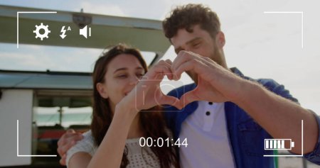 Photo for Image of a young Caucasian couple, seen on a screen of a digital camera in record mode with icons and timer 4k - Royalty Free Image