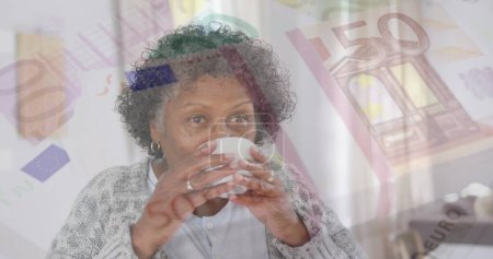 Photo for Image of senior woman drinking tea over euro currency bills. retirement and finances concept digitally generated image. - Royalty Free Image
