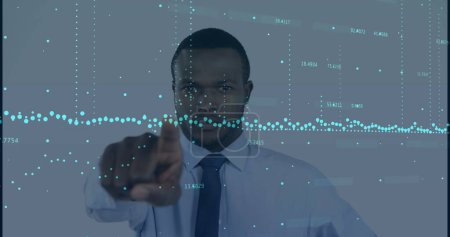 Image of financial data over african american businessman. global business, finance, technology and data processing concept digitally generated image.