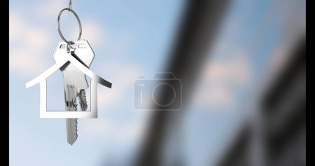 Photo for Image of keys with house keychain over blurred background. Moving house and digital interface concept digitally generated image. - Royalty Free Image