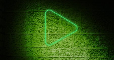 Photo for Image of a green arrow neon sign on brick wall - Royalty Free Image