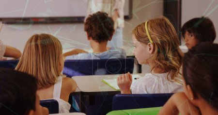 Photo for Image of shapes moving over diverse schoolchildren in classroom. Global education and digital interface concept digitally generated image. - Royalty Free Image