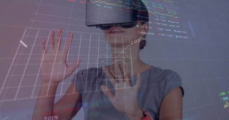 Photo for Image of financial data processing over businesswoman using vr headset. global business, connections, digital interface and technology concept digitally generated image. - Royalty Free Image