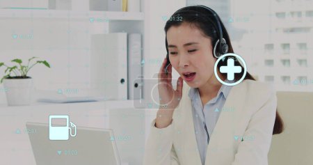 Photo for Image of data processing over asian female doctor using laptop and headphones. Global medicine and data processing concept digitally generated image. - Royalty Free Image