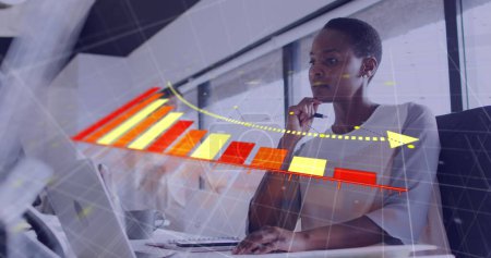 Image of financial data processing over african american businesswoman in office. Global business, finances, computing and data processing concept digitally generated image.