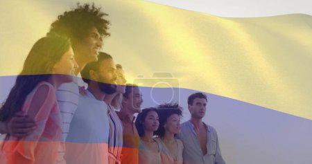 Photo for Image of flag of colombia waving over diverse friends forming human chain and looking at sea. Digital composite, multiple exposure, togetherness, friendship, freedom, government and patriotism. - Royalty Free Image