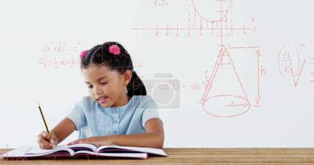 Image of math formulas over happy biracial girl doing homework. learning, education and school concept digitally generated image.