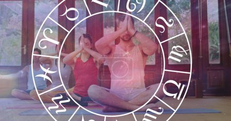 Photo for Image of horoscope zodiac wheel over diverse people practicing yoga. Star signs, horoscope and yoga meditation concept digitally generated image. - Royalty Free Image