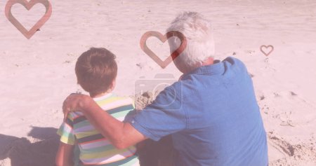 Téléchargez les photos : Image de cœurs tombant sur un homme caucasien et son petit-fils à la plage. mode et style de vie concept, image générée numériquement. - en image libre de droit