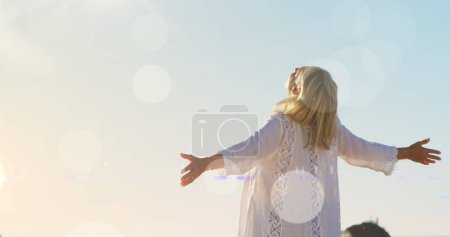 Photo for Image of light spots over disabled caucasian woman with arms outstretched. never give up day and celebration concept, digitally generated image. - Royalty Free Image