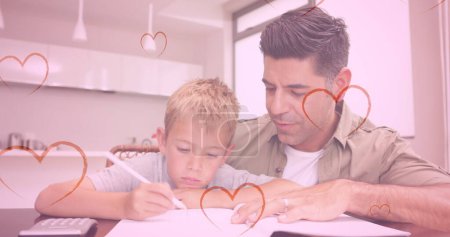 Image of hearts falling over caucasian man and his son doing homework. fashion and lifestyle concept, digitally generated image.