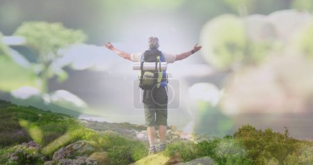 Photo for Image of meadow over senior caucasian man with arms outstretched. never give up day and celebration concept, digitally generated image. - Royalty Free Image