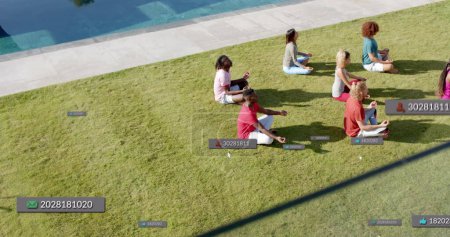 Photo for Image of social media notifications over diverse yoga group meditating in sun. Meditation, wellbeing, social network, digital interface, internet and communication, digitally generated image. - Royalty Free Image