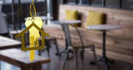 Image of hanging golden house keys against interior of a cafe. Interior designing and real estate concept