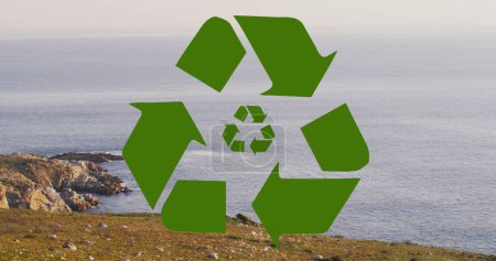 Image of recycling, sustainability and ecology icons over landscape. Ecology, sustainability and data processing concept digitally generated image