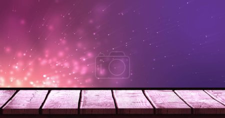 Image of lights over violet background with wooden surface. backgrounds, textures and layouts concept digitally generated image.