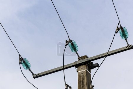 Photo for A wooden electricity pole with green insulators - Royalty Free Image