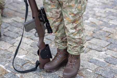 Die Beine eines litauischen Tarnsoldaten und sein Gewehr