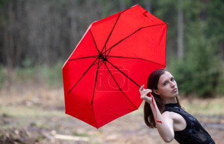 Photo for Beautiful young woman with umbrella outdoors on rainy day - Royalty Free Image