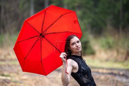 Photo for Beautiful young woman with umbrella outdoors on rainy day - Royalty Free Image