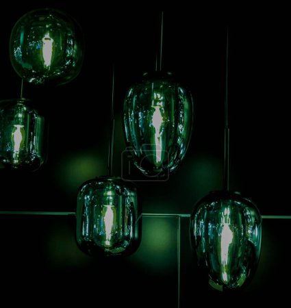 Photo for Attractive green lights in the night. Green lamp in the interior of the house. Charming  green lanterns. - Royalty Free Image