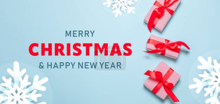 Photo for 2023 Merry Christmas and Happy Holidays greeting card banner. New Year. Noel. Christmas gifts red ribbons, ornaments on blue background top view. Winter holiday xmas theme. Flat lay. - Royalty Free Image