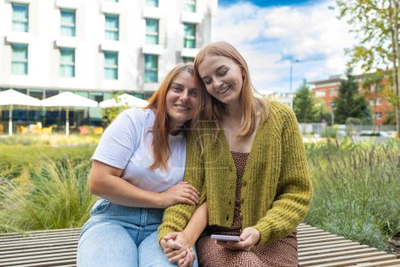 Photo for Cheerful two young european women friend hugging outdoors at park. High quality photo - Royalty Free Image