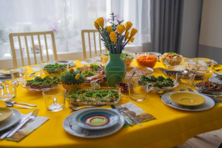 Photo for Traditional Polish Easter breakfast on a festive table with bright stylish decor and classic dishes on a yellow tablecloth. Festive family table - Royalty Free Image