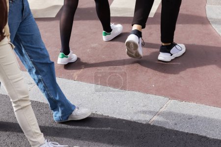 Photo for Closup picture of legs of young people crossing a city street - Royalty Free Image
