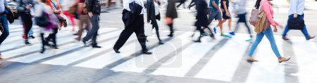 Photo for Picture with motion blur of crowds of people who crossing a city street - Royalty Free Image