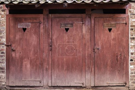 Photo for Picture of wooden doors of antique toilets with the German signs Fuer Maenner and Fuer Frauen, meaning for men and for women - Royalty Free Image