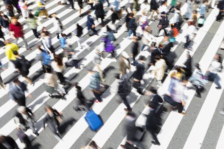 Téléchargez les photos : Image avec flou de mouvement intentionnel de foules de personnes qui traversent une rue de la ville à un passage de zèbre à Tokyo, Japon - en image libre de droit