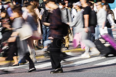 Photo for Picture with intentional motion blur effect of crowds of people crossing the Shibuya crossing in Tokyo, Japan - Royalty Free Image