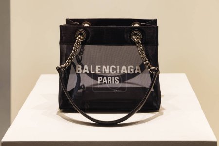 Photo for Osaka, Japan - April 13, 2023: Luxury handbag in an illuminated window of a Balenciaga store at night in Osaka. Balenciaga is a Spanish luxury fashion house founded in 1919 - Royalty Free Image