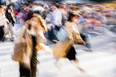 Photo for Picture with motion blur effect of crowds of people crossing the famous Shibuya Crossing in Tokyo, Japan - Royalty Free Image