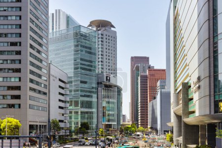 Photo for Osaka, Japan - April 12, 2023: Street view with high-rise buildings in Umeda, Osaka. Umeda is a commercial and business district with many hotels and office buildings in the Kita-ku district - Royalty Free Image