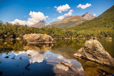 Remote rural South Mavora  Lake surrounded by lush native forest with stunning cloud and mountain reflections on the lake surface.