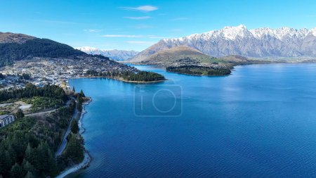Photo for Drone panoramic view of the bays and inlets at Queenstown town at the southern end of Lake Wakatipu with a backdrop of the snow capped Remarkables Mountain range - Royalty Free Image