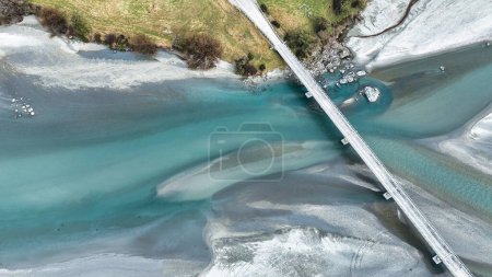 Photo for Aerial drone scenery of the braided Dart river flowing through a rural valley bordered by the Southern Alps mountains into Lake Wakatipu near Glenorchy - Royalty Free Image