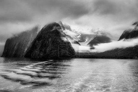 Photo for Black and white version of Mitre Peak in Milford sound in stormy rain cloud and mist - Royalty Free Image