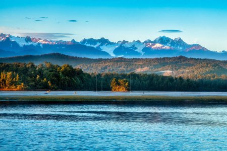 The snow covered Southern alps views from the West Coast Okarito Lagoon at sunrise