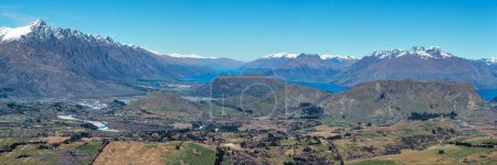 Panorama of Queenstown valley and Lake Wakatipu from the top of the alpine Crown Range road across the mountains