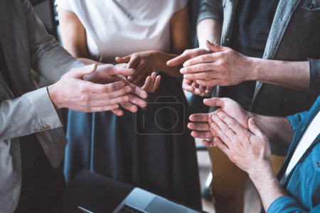 Photo for Close-up shot, multi-ethnic business team stands together, celebrating success with applause. Power of collaboration and support within a professional and corporate setting. High quality photo - Royalty Free Image