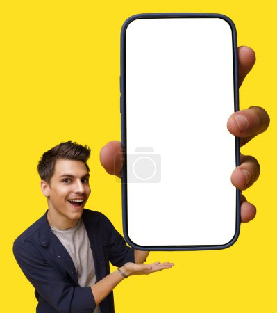 Photo for Young student holds mobile device with large white screen, offering ample copy space for advertising and promotional messages. Yellow background adds pop of color to image. High quality photo - Royalty Free Image