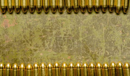 Photo for A line of spent bullet casings is displayed against a gritty and worn background, showcasing the aftermath of gunfire. - Royalty Free Image
