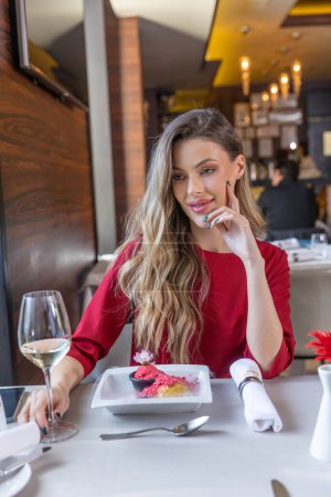 Photo for Happy woman eating frozen dessert in the restaurant - Royalty Free Image